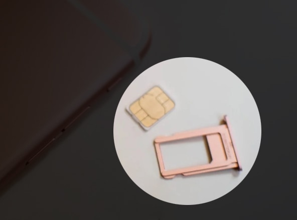Carefully lift the SIM card out of the tray and set it aside.