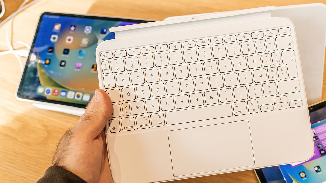 Image: Person holding iPad keyboard.
