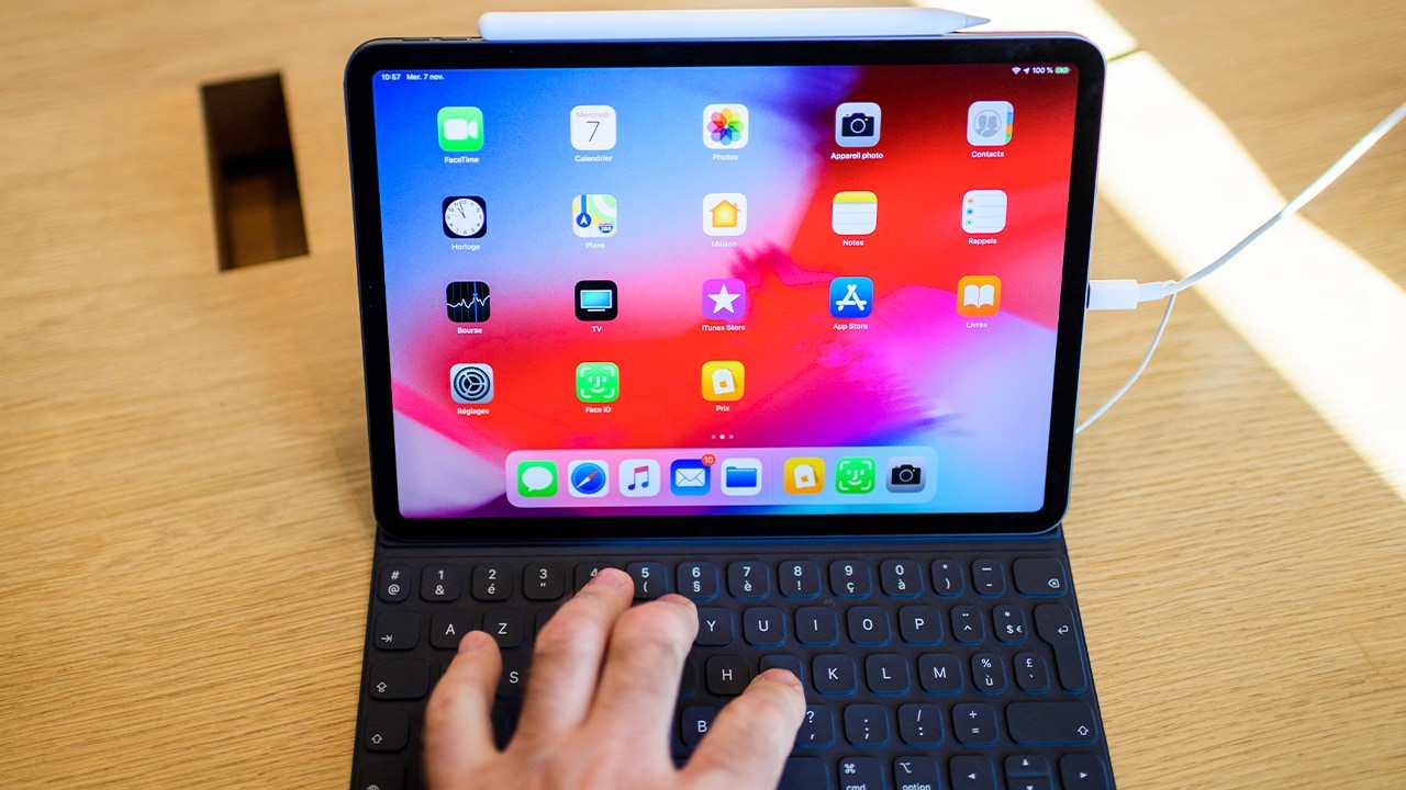 Image: Person using an iPad with a keyboard attached.